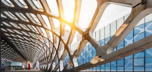Connected architectural framework beside a glass building.
